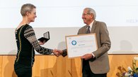 Presentation of the medal and certificate, Susanne Buiter and Mark D. Zoback shake hands