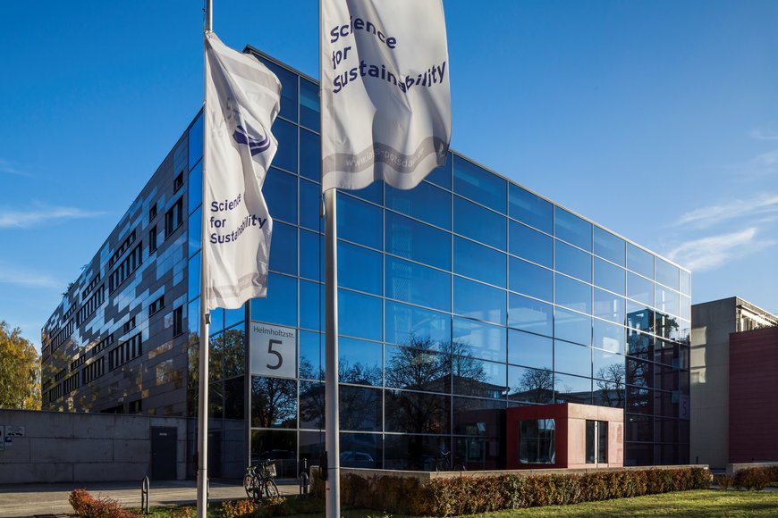 glas building RIFS in Potsdam, with flags in the foreground