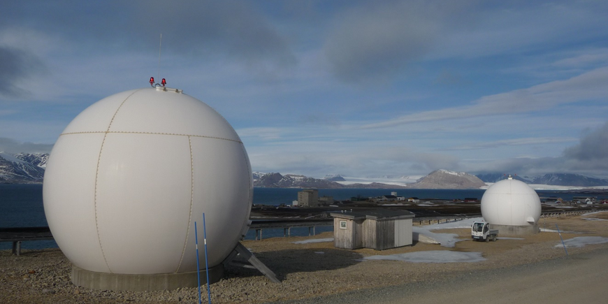 2 large spheres in the landscape. inside are the satellite receiving stations.