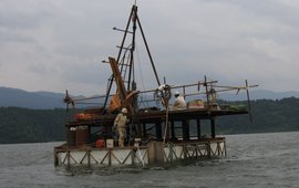 You can see a small drilling platform on a lake with two people