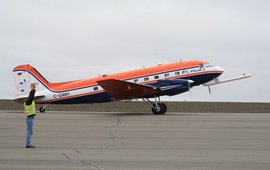 The photo shows a small aeroplane on the runway