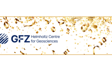 The new GFZ logo with a new name: Helmholtz Centre for Geosciences. Golden tinsel curls in the background.