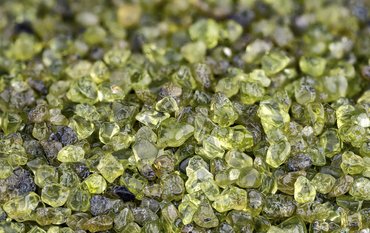 Close-up on a bed of green angular olivine crystals